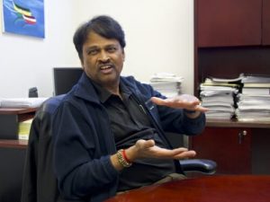 Srinivasan Damodaran talking while sitting at an office desk